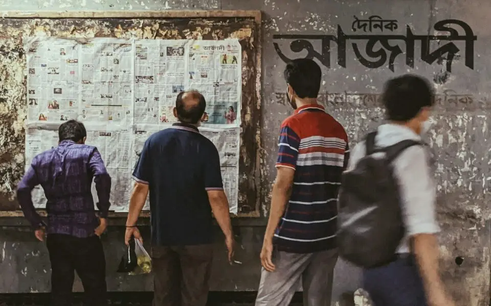 a group of people standing in front of a bulletin board