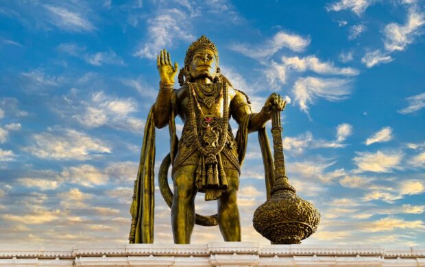 a statue of a man holding a staff