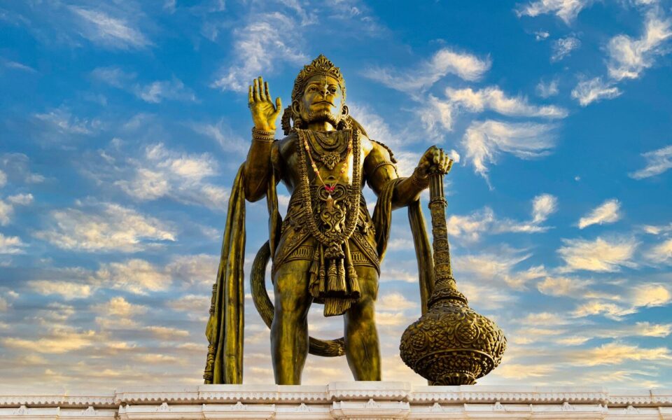 a statue of a man holding a staff