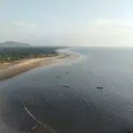 a group of boats floating on top of a large body of water