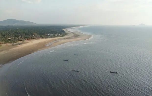 a group of boats floating on top of a large body of water