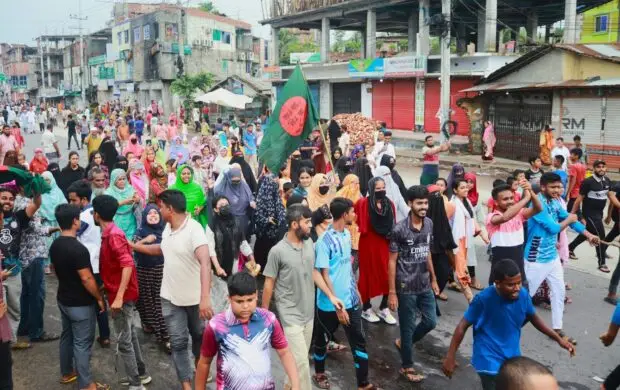 A large group of people walking down a street